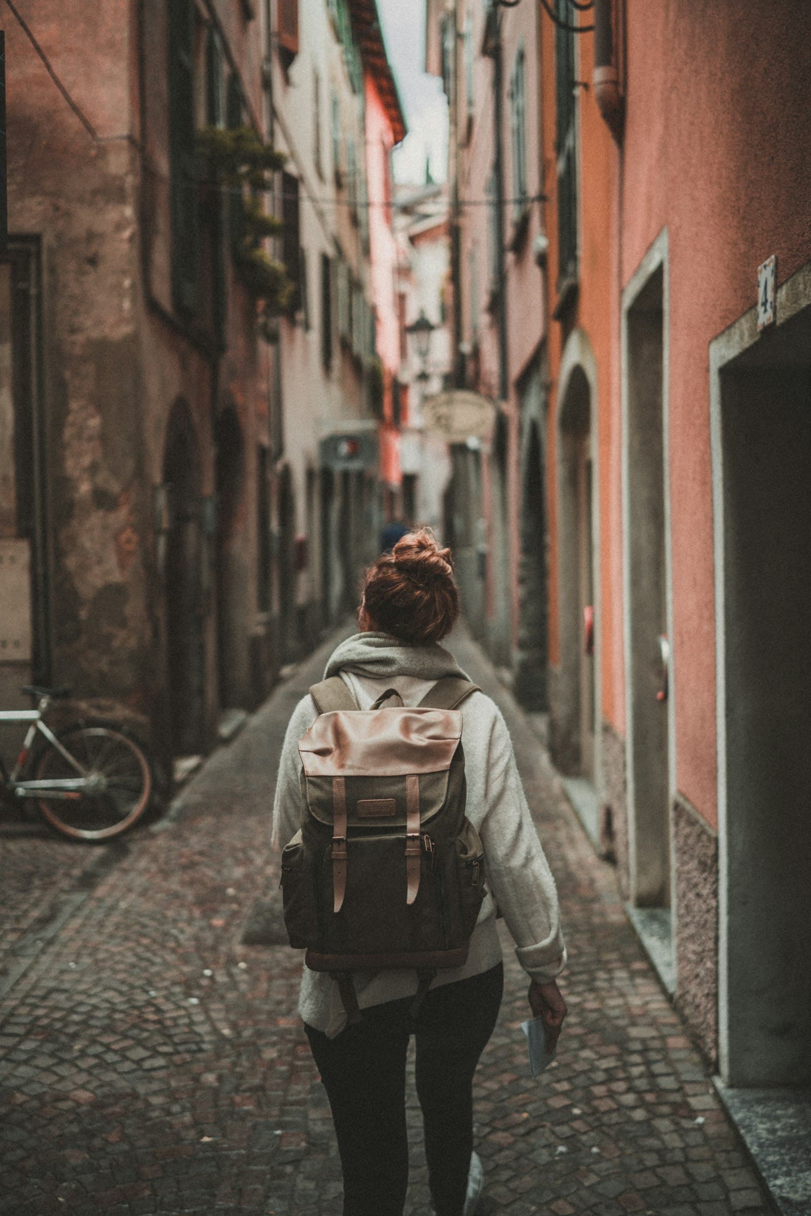 Traveller with a backpack in a narrow old-town street